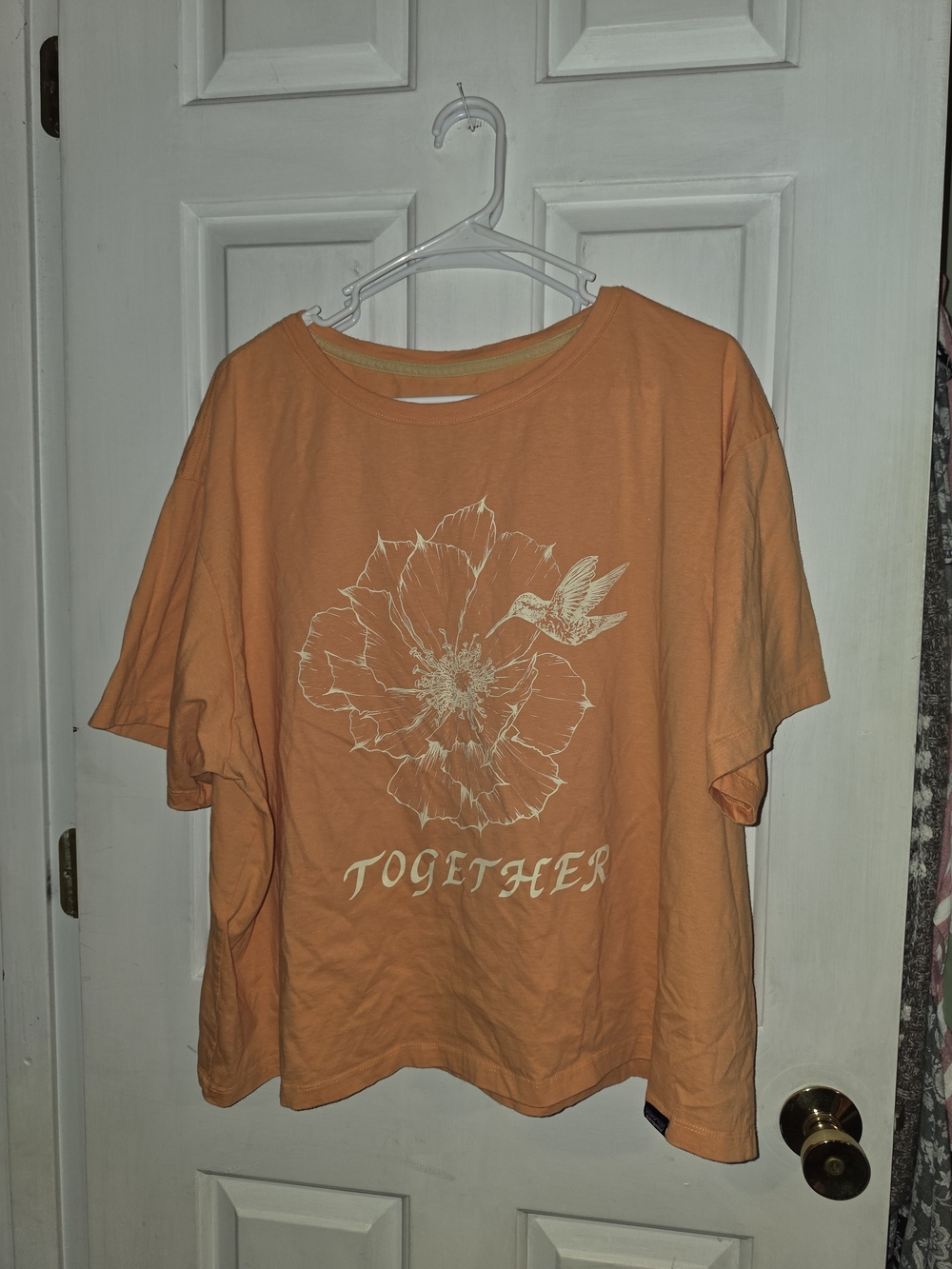 Patagonia Orange Short Sleeve Tee with White Floral & Hummingbird Graphic